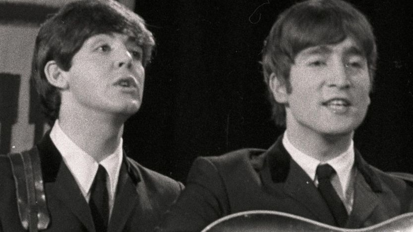 Paul McCartney and John Lennon of the Beatles performing