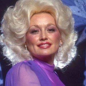 Dolly Parton posing in front of butterflies