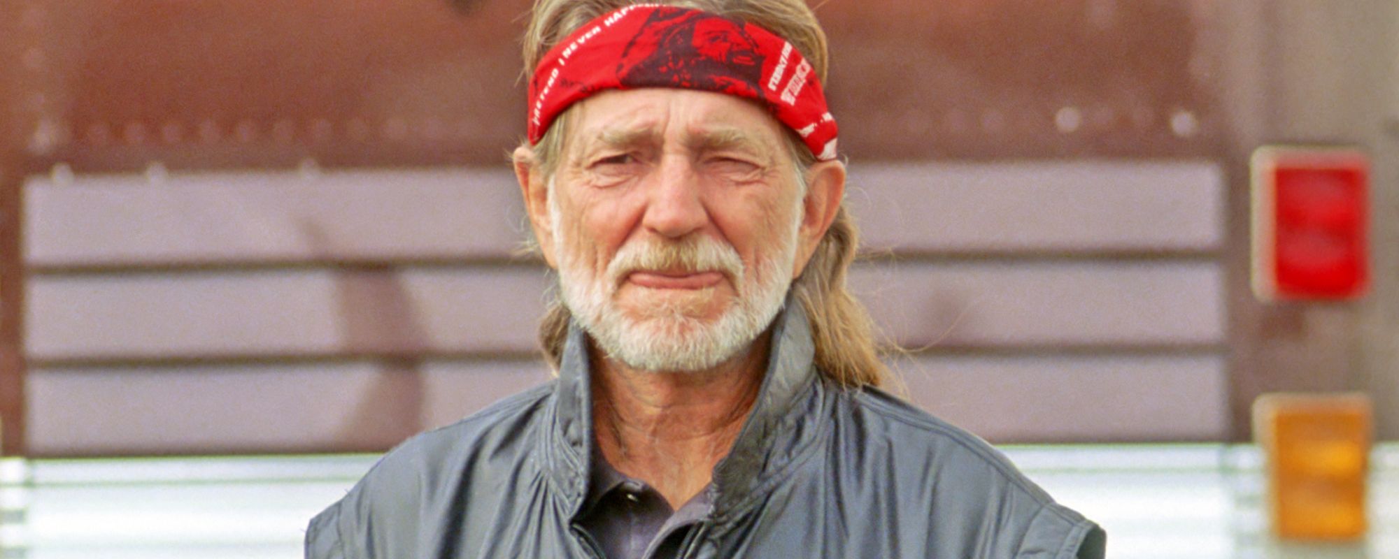 Willie Nelson in front of tour bus