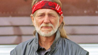 Willie Nelson in front of tour bus