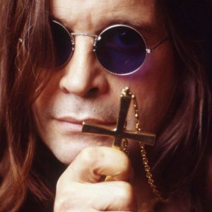 Ozzy Osbourne holding cross