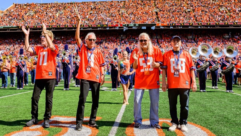 Watch REO Speedwagon Members Reunite for Special Performance with U. of Illinois Marching Band at the School’s Football Game