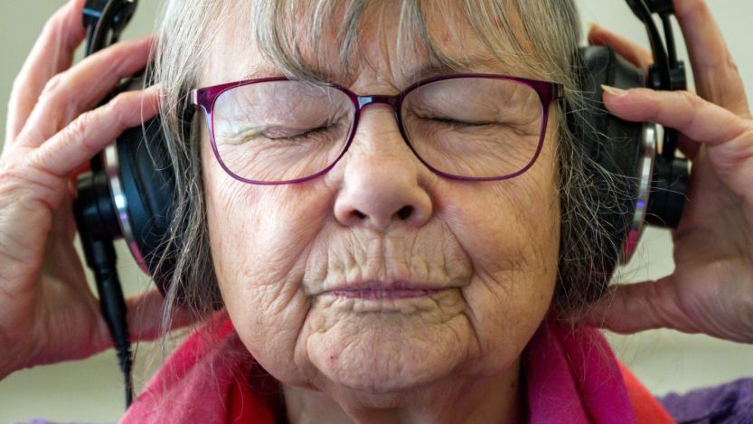 Older woman listening to music