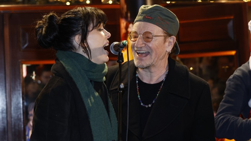 Watch U2’s Bono Sing Rocking Classic Holiday Tune with Imelda May at Annual Christmas Eve Charity Busking Event in Dublin