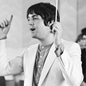 Paul McCartney of The Beatles conducting a choir