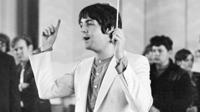 Paul McCartney of The Beatles conducting a choir