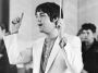 Paul McCartney of The Beatles conducting a choir