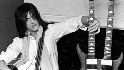 Joe Perry of Aerosmith posing with guitars