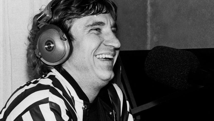 Joe Walsh talking into microphone