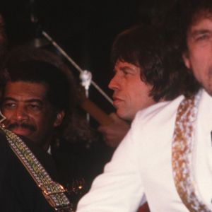 Traveling Wilburys members George Harrison and Bob Dylan performing