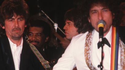 Traveling Wilburys members George Harrison and Bob Dylan performing