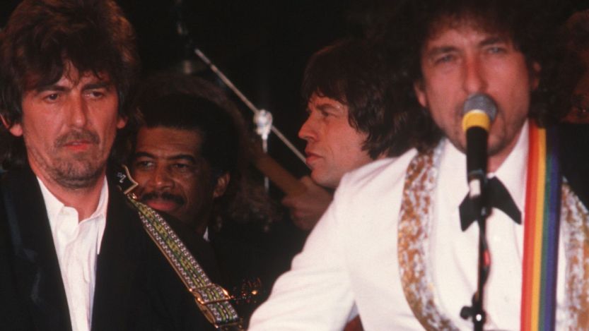 Traveling Wilburys members George Harrison and Bob Dylan performing