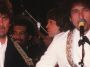 Traveling Wilburys members George Harrison and Bob Dylan performing