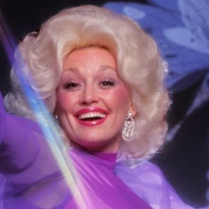 Dolly Parton performing with butterfly in background