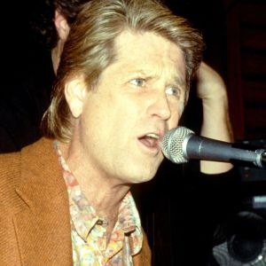 Brian Wilson playing the piano and singing