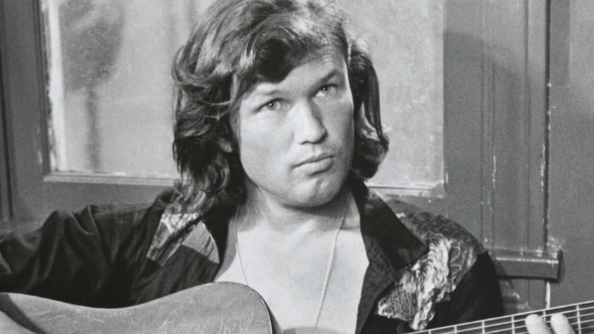 Kris Kristofferson playing guitar