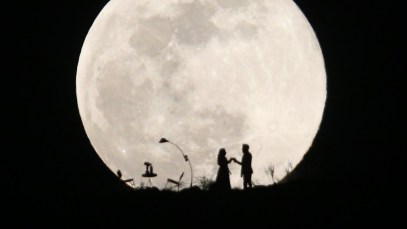 KAYSERI, TURKEY - FEBRUARY 19: A couple dance on a hill as the Supermoon is seen in Turkey's Kayseri on February 19, 2019. The Supermoon is a full moon that almost coincides with the closest distance that the Moon reaches to Earth in its elliptic orbit, resulting in a larger-than-usual visible size of the lunar disk as seen from Earth. (Photo by Sercan Kucuksahin/Anadolu Agency/Getty Images)