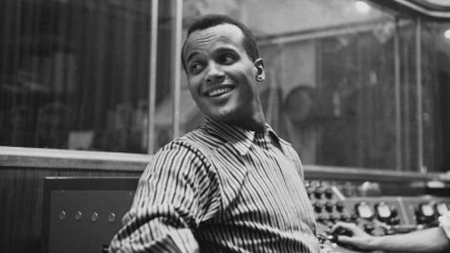 American singer-songwriter and civil rights activist Harry Belafonte, wearing a striped shirt, in an recording studio, circa 1957. The sound engineer is visible working at the console to the right of the frame. (Photo by Archive Photos/Hulton Archive/Getty Images)