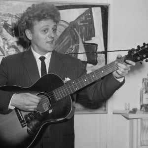 Rock and Roll musician and singer Wee Willie Harris playing an acoustic guitar, July 21st 1958. (Photo by Daily Express/Hulton Archive/Getty Images)