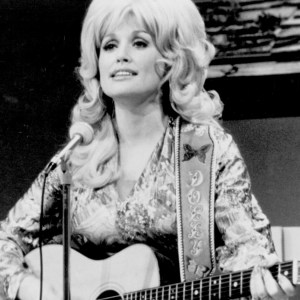 1974: Country singer Dolly Parton performs onstage with an acoustic guitar in circa 1974. (Photo by Michael Ochs Archives/Getty Images)
