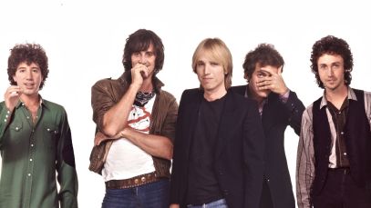 Tom Petty and the Heartbreakers posing on white background
