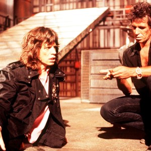 Singer Mick Jagger and guitarist Keith Richards of the Rolling Stones on the set of the music video for 'One Hit (To the Body)' in England in May 1986. (Photo by Michael Putland/Getty Images)