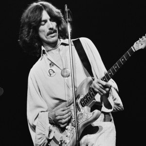 English musician, singer-songwriter, and producer George Harrison (1943 - 2001) performing on stage playing his 'Rocky' Sonic Blue Fender Stratocaster during his 'George Harrison and Ravi Shankar's 1974 North American tour' also known as the 'Dark Horse Tour' in North America, 1974. (Photo by Steve Morley/Redferns/Getty Images)