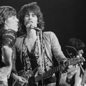 Mick Jagger, Keith Richards and Bill Wyman (behind) of the Rolling Stones perform live on stage at The Roundhouse in London on 14th March 1971. Keith Richards is playing his Ampeg Dan Armstrong guitar. (Photo by Evening Standard/Hulton Archive/Getty Images)