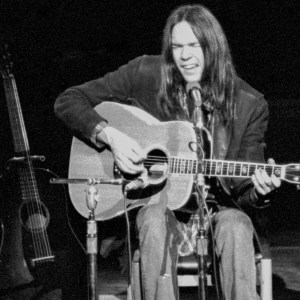 Neil Young performs on stage at the Royal Festival Hall, London on his 'Journey Through The Past' solo tour, 27th February 1971. (Photo by Gijsbert Hanekroot/Redferns)