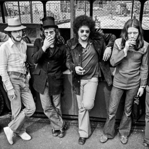Stealers Wheel, group portrait by an old bus in Amsterdam, Netherlands, 1973. L-R Rod Coombes, Gerry Rafferty, Rab Noakes, DeLisle Harper, Luther Grosvenor, Joe Egan. (Photo by Gijsbert Hanekroot/Redferns)