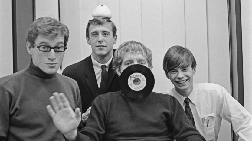 American rock group The Cyrkle (American drummer Marty Fried, American singer and guitarist Don Dannemann, American singer and guitarist Tom Dawes (1944-2007), and American keyboard player Michael Losekamp), pose with Dawes having an unspecified Okeh Records seven-inch record over his mouth, location unspecified, circa 1965. (Photo by Don Paulsen/Michael Ochs Archives/Getty Images)