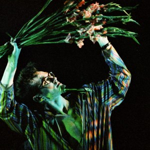 LONDON, UNITED KINGDOM - MARCH 12: Morrissey of The Smiths waves a bunch of gladioli while performing on stage at Hammersmith Palais, on March 12th, 1984 in London, England. (Photo by Pete Still/Redferns)