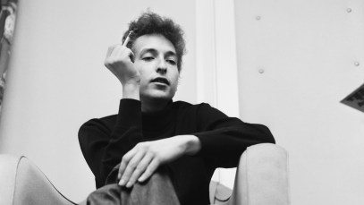 American folk singer Bob Dylan smokes a cigarette in his hotel room during his visit to London. 11th May 1964. (Photo by Daily Mirror/Daily Mirror/Mirrorpix via Getty Images)