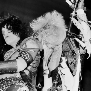 View of American Heavy Metal musicians Nikki Sixx (born Frank Feranna Jr) (left), on bass guitar, and vocalist Vince Neil (born Vincent Neil Wharton), both of the group Motley Crue, as they perform onstage, during the 'Shout at the Devil' tour, at Nassau Coliseum (later Nassau Veterans Memorial Coliseum), Uniondale, New York, January 25, 1984. (Photo by Gary Gershoff/Getty Images)