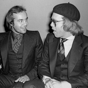 View of English Rock & Pop songwriting duo, lyricist Bernie Taupin (second right) and musician Elton John (right) at the Studio 54 nightclub, New York, New York, 1970s. The men at left are unidentified. (Photo by Allan Tannenbaum/Getty Images)