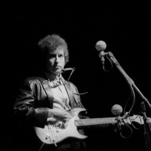 NEWPORT, RI - JULY 25: Bob Dylan plays a Fender Stratocaster electric guitar for the first time on stage as he performs at the Newport Folk Festival with guitarist Mike Bloomfield on July 25, 1965 in Newport, Rhode Island. (Photo by Alice Ochs/Michael Ochs Archives/Getty Images)