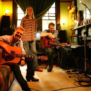 (AUSTRALIA OUT) Ex Moving Pictures frontman Alex Smith, front, Charlie Cole, behind him, and Dave Carter, in the Bondi Junction loungeroom where Smith penned his songs, 27 July 2005. SMH Picture by SAHLAN HAYES (Photo by Fairfax Media via Getty Images/Fairfax Media via Getty Images via Getty Images)