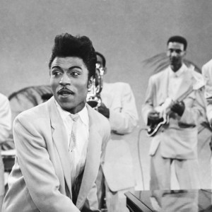 CIRCA 1957: Musician Little Richard performs onstage with his band as his saxophone player Grady Gaines stands on the piano in circa 1957 in scene from the movie 'Mister Rock And Roll.' (Photo by Michael Ochs Archives/Getty Images)