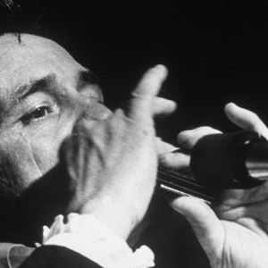 American country singer, songwriter and musician Johnny Cash (1932 - 2003) performing with a harmonica, circa 1970. (Photo by Archive Photos/Getty Images)
