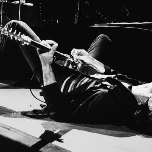 LOS ANGELES, CA - July 5: Rock and roll icon Bruce Springsteen falls to the stage and continues playing the guitar on his back on July 5, 1978 at the Forum in Inglewood, California. (Photo by George Rose/Getty Images)