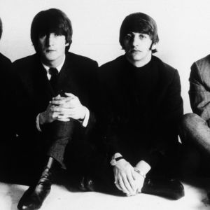 The Beatles sitting on floor