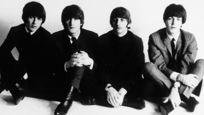 The Beatles sitting on floor