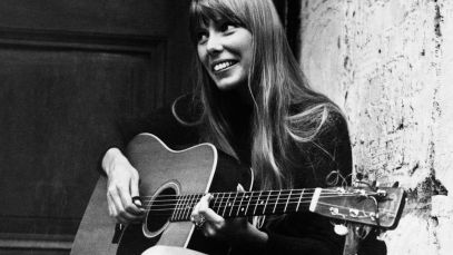 Joni Mitchell playing guitar