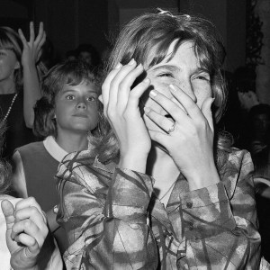 (Original Caption) 9/21/1964-New York, New York- This teen-ager isn't in pain she is just filled with ecstacy as she sees, but doesn't really hear, her beloved Beatles. A barrage of jellybeans and their wrappers greeted the Beatles when they appeared on stage. Flashbulbs popped continually ans some members of the audience waved tiny flashlights.