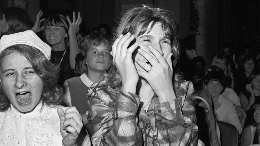 (Original Caption) 9/21/1964-New York, New York- This teen-ager isn't in pain she is just filled with ecstacy as she sees, but doesn't really hear, her beloved Beatles. A barrage of jellybeans and their wrappers greeted the Beatles when they appeared on stage. Flashbulbs popped continually ans some members of the audience waved tiny flashlights.