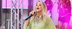 Carrie Underwood Stuns in Show-Stopping Red Gown as She Urges Fans to Listen to Her Christmas Albums