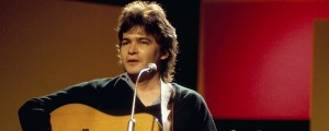 Behind the Meaning of John Prine’s “Your Flag Decal Won’t Get You Into Heaven Anymore”