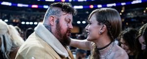 Bunnie Xo Watches on as Jelly Roll “Finally Gets to Meet His Crush” Taylor Swift at the GRAMMYs