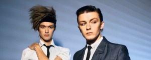 4 Songs Actor and Comedian Ricky Gervais Wrote for His ’80s Synth-Pop Band Seona Dancing, David Bowie, and ‘The Simpsons’