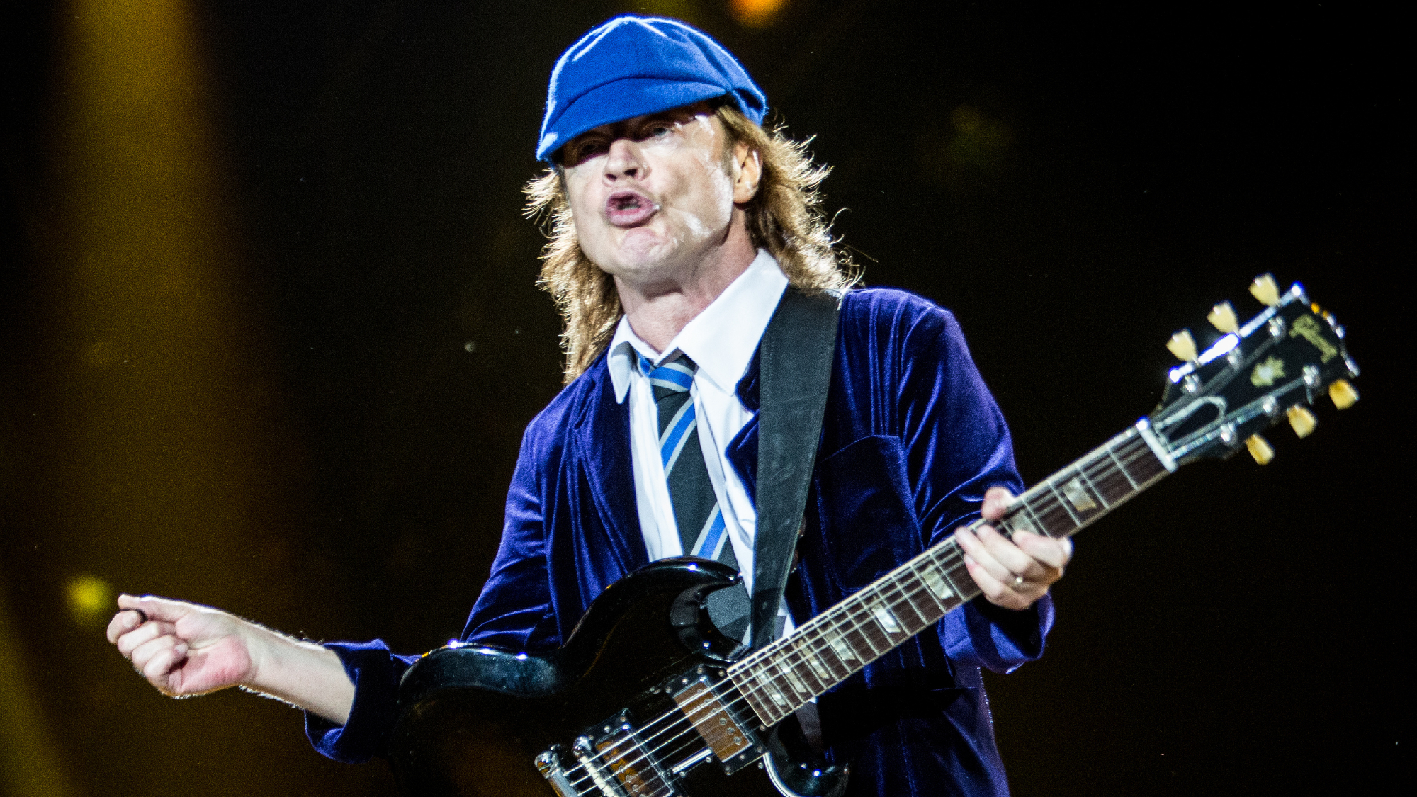 AC/DC's Angus Young Signs a Baby During Surprise Appearance After Canceled  Toronto Show - American Songwriter